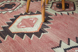 Vintage kilim rug in living room setting, old rug, antique rug, pastel colors, faded colors, Turkish rug, vintage rug, soft rug, Portland, Oregon, rug store, rug shop, local shop, earthy tones, earthy colors