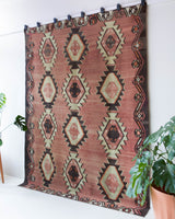 Vintage kilim rug in living room setting, old rug, antique rug, pastel colors, faded colors, Turkish rug, vintage rug, soft rug, Portland, Oregon, rug store, rug shop, local shop, earthy tones, earthy colors