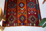 Vintage Turkish runner rug in a living room setting, pile rug, Turkish rug, vintage rug, portland, rug shop, bright colors, wild shaman, soft rug, bold color, Portland, Oregon, rug store, rug shop, local shop, antique rug
