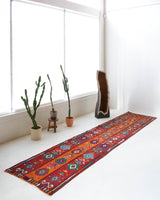 Vintage Turkish runner rug in a living room setting, pile rug, Turkish rug, vintage rug, portland, rug shop, bright colors, wild shaman, soft rug, bold color, Portland, Oregon, rug store, rug shop, local shop, antique rug