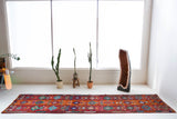 Vintage Turkish runner rug in a living room setting, pile rug, Turkish rug, vintage rug, portland, rug shop, bright colors, wild shaman, soft rug, bold color, Portland, Oregon, rug store, rug shop, local shop, antique rug