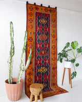 Vintage Turkish runner rug in a living room setting, pile rug, Turkish rug, vintage rug, portland, rug shop, bright colors, wild shaman, soft rug, bold color, Portland, Oregon, rug store, rug shop, local shop, antique rug