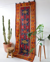 Vintage Turkish runner rug in a living room setting, pile rug, Turkish rug, vintage rug, portland, rug shop, bright colors, wild shaman, soft rug, bold color, Portland, Oregon, rug store, rug shop, local shop, antique rug