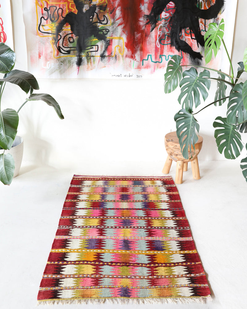 Vintage kilim rug in room decor setting, old rug, antique rug, pastel colors, faded colors, Turkish rug, vintage rug, soft rug, Portland, Oregon, rug store, rug shop, local shop,  antique kilim rug, bold colors, bright colors, faded colors