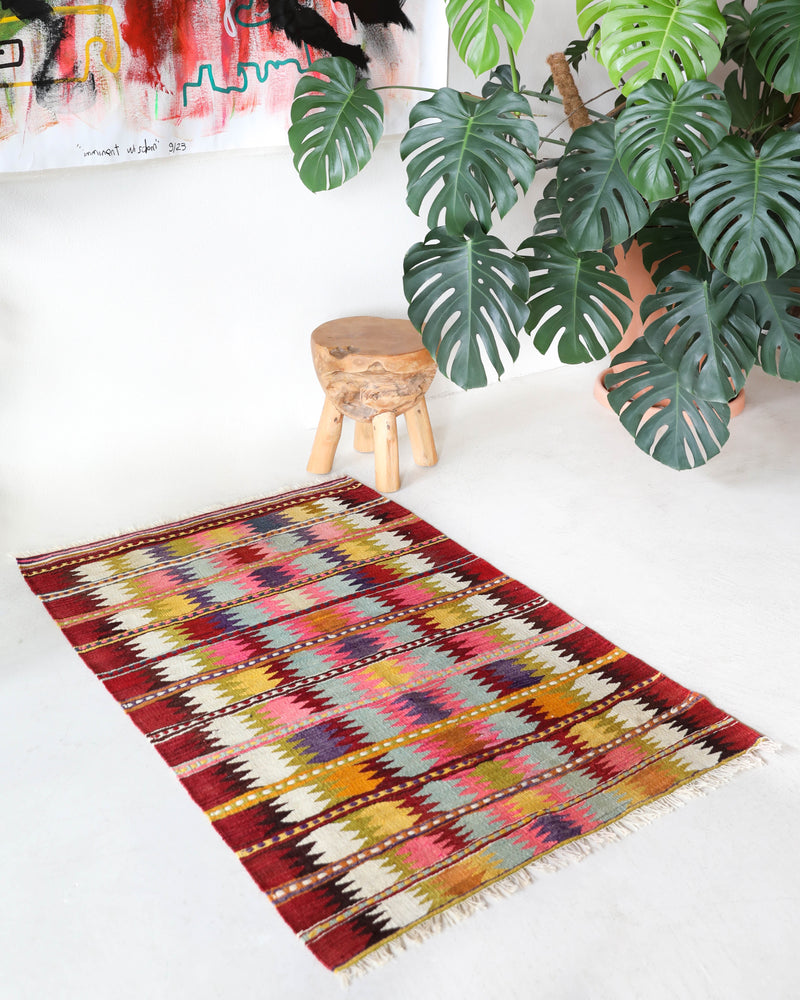 Vintage kilim rug in room decor setting, old rug, antique rug, pastel colors, faded colors, Turkish rug, vintage rug, soft rug, Portland, Oregon, rug store, rug shop, local shop,  antique kilim rug, bold colors, bright colors, faded colors