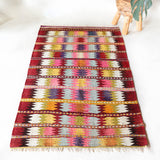 Vintage kilim rug in room decor setting, old rug, antique rug, pastel colors, faded colors, Turkish rug, vintage rug, soft rug, Portland, Oregon, rug store, rug shop, local shop,  antique kilim rug, bold colors, bright colors, faded colors