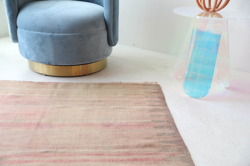 Vintage kilim rug in living room setting, old rug, antique rug, pastel colors, faded colors, Turkish rug, vintage rug, soft rug, Portland, Oregon, rug store, rug shop, local shop, earthy tones, earthy colors, warm colors