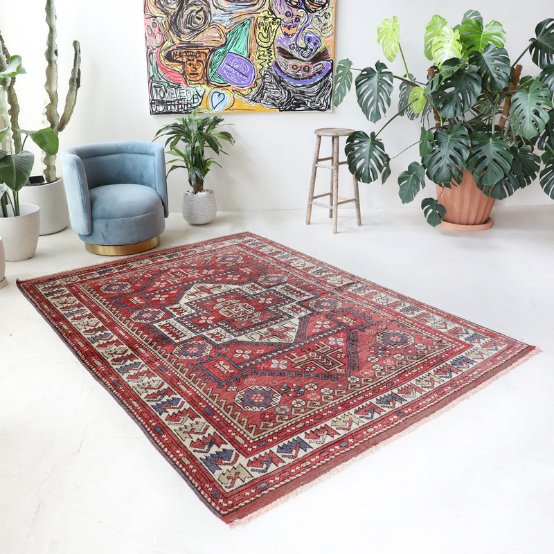 Vintage kilim rug in living room setting, old rug, antique rug, pastel colors, faded colors, Turkish rug, vintage rug, soft rug, Portland, Oregon, rug store, rug shop, local shop, earthy tones, earthy colors, warm colors