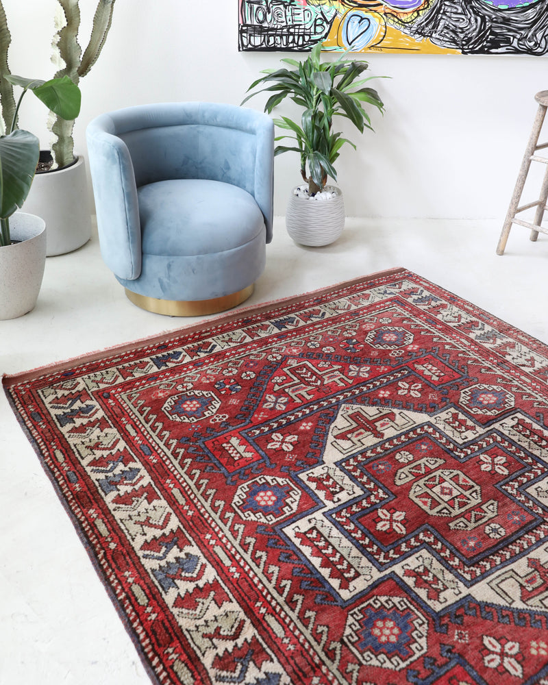 Vintage kilim rug in living room setting, old rug, antique rug, pastel colors, faded colors, Turkish rug, vintage rug, soft rug, Portland, Oregon, rug store, rug shop, local shop, earthy tones, earthy colors, warm colors