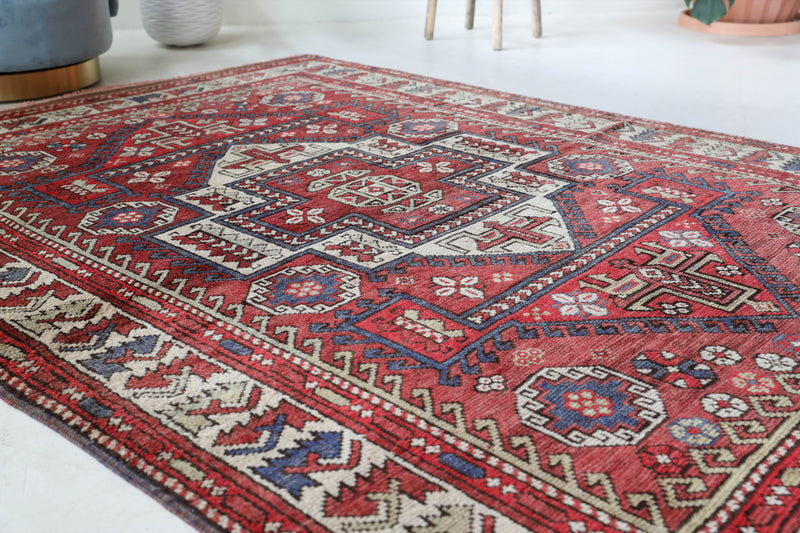 Vintage kilim rug in living room setting, old rug, antique rug, pastel colors, faded colors, Turkish rug, vintage rug, soft rug, Portland, Oregon, rug store, rug shop, local shop, earthy tones, earthy colors, warm colors