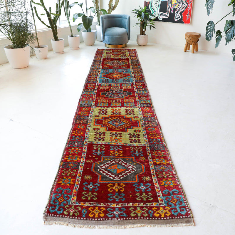 Vintage Turkish runner rug in a living room setting, pile rug, Turkish rug, vintage rug, portland, rug shop, bright colors, wild shaman, soft rug, bold color, Portland, Oregon, rug store, rug shop, local shop, antique rug