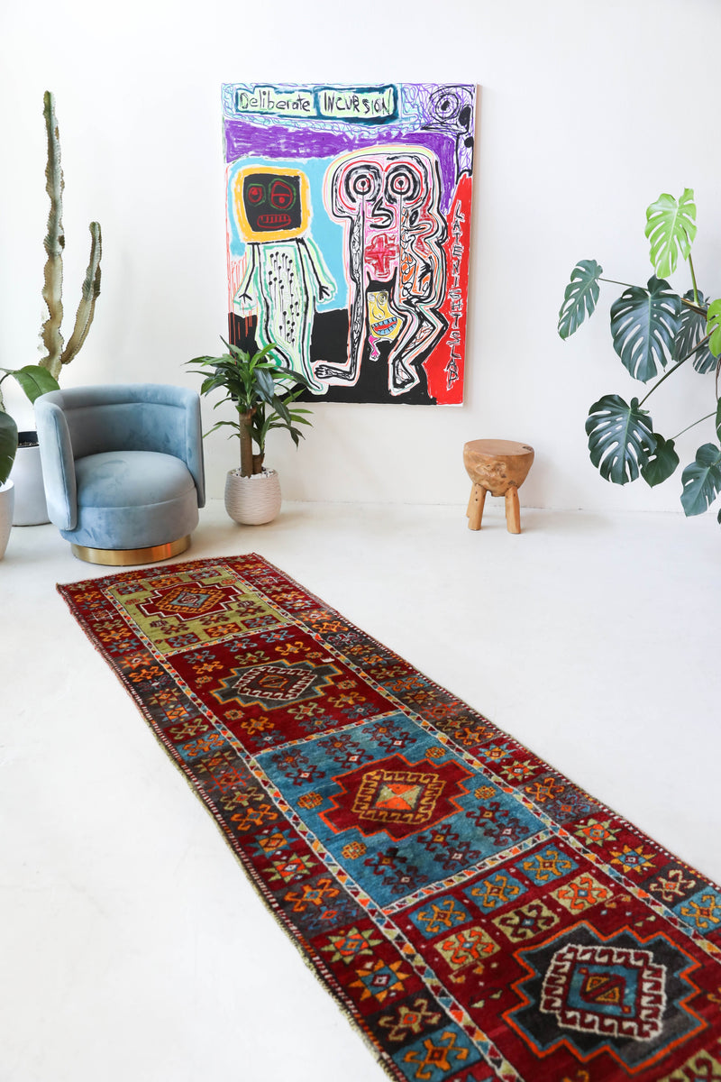 Vintage Turkish runner rug in a living room setting, pile rug, Turkish rug, vintage rug, portland, rug shop, bright colors, wild shaman, soft rug, bold color, Portland, Oregon, rug store, rug shop, local shop, antique rug