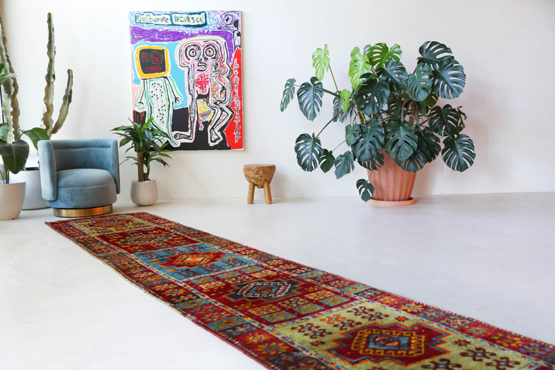 Vintage Turkish runner rug in a living room setting, pile rug, Turkish rug, vintage rug, portland, rug shop, bright colors, wild shaman, soft rug, bold color, Portland, Oregon, rug store, rug shop, local shop, antique rug