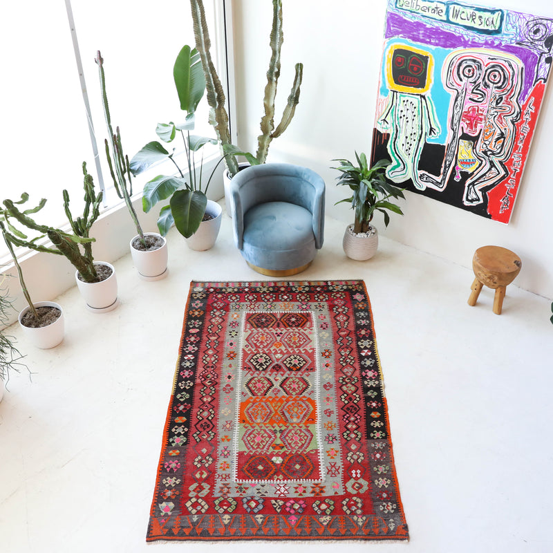 Vintage kilim rug in room decor setting, old rug, antique rug, pastel colors, faded colors, Turkish rug, vintage rug, soft rug, Portland, Oregon, rug store, rug shop, local shop,  antique kilim rug, bold colors, bright colors, faded colors