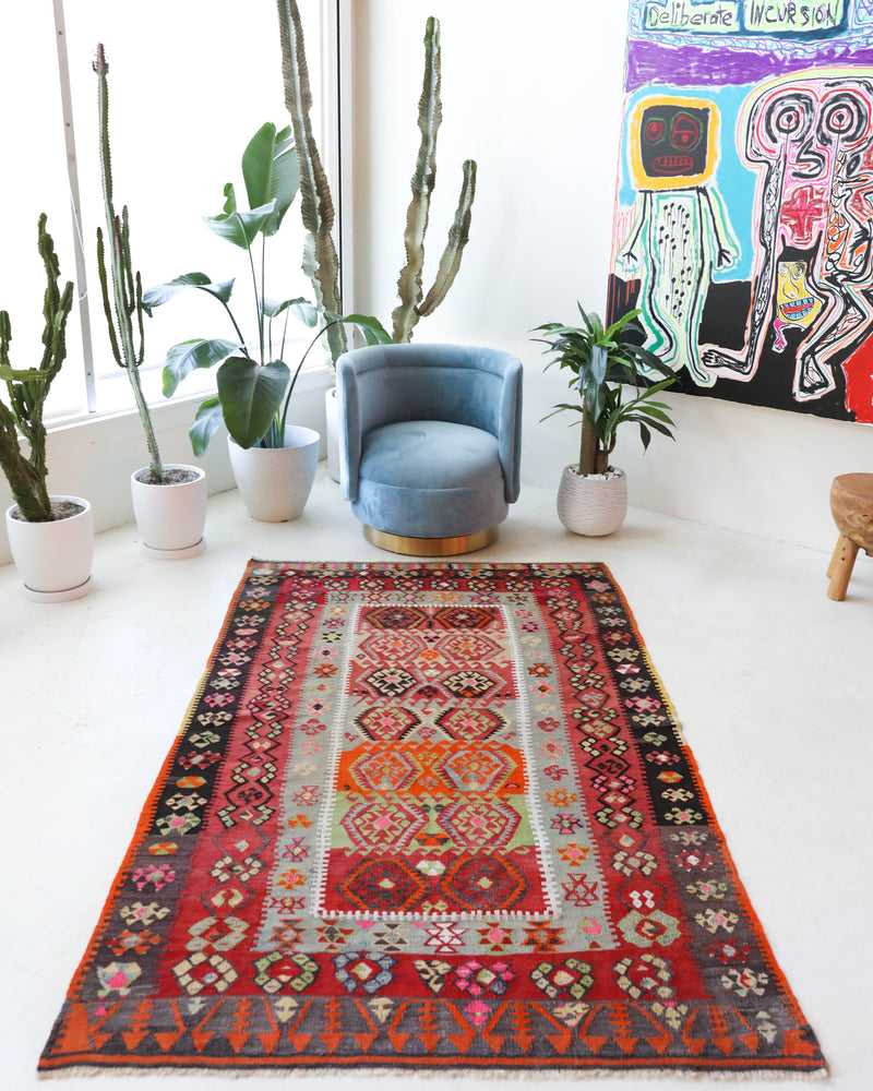 Vintage kilim rug in room decor setting, old rug, antique rug, pastel colors, faded colors, Turkish rug, vintage rug, soft rug, Portland, Oregon, rug store, rug shop, local shop,  antique kilim rug, bold colors, bright colors, faded colors