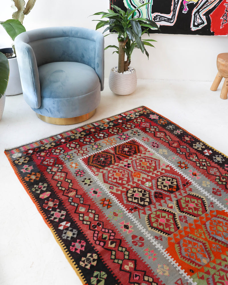 Vintage kilim rug in room decor setting, old rug, antique rug, pastel colors, faded colors, Turkish rug, vintage rug, soft rug, Portland, Oregon, rug store, rug shop, local shop,  antique kilim rug, bold colors, bright colors, faded colors