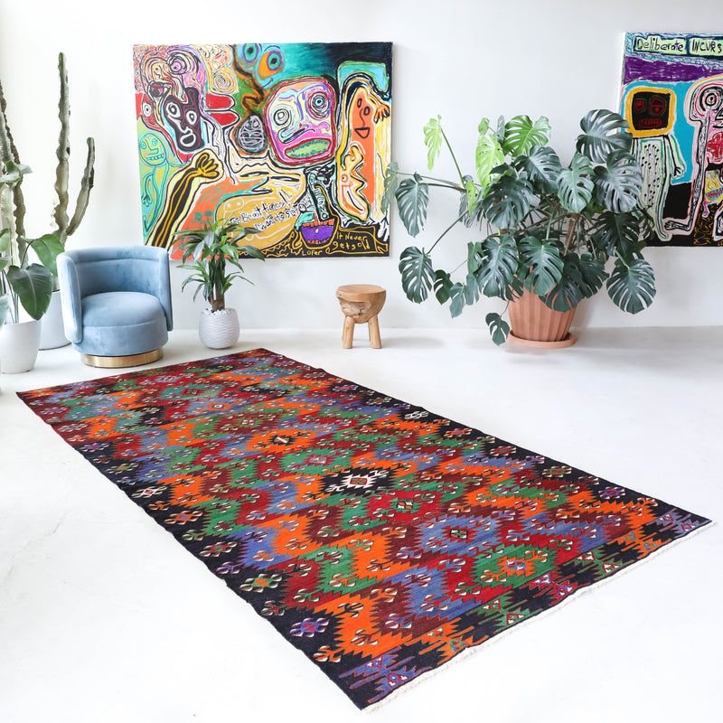 Vintage kilim rug in living room setting, bright colors, wild shaman, soft rug, bold color, Portland, Oregon, rug store, rug shop, local shop, vintage rug, modern kilim, warm colors, antique kilim rug