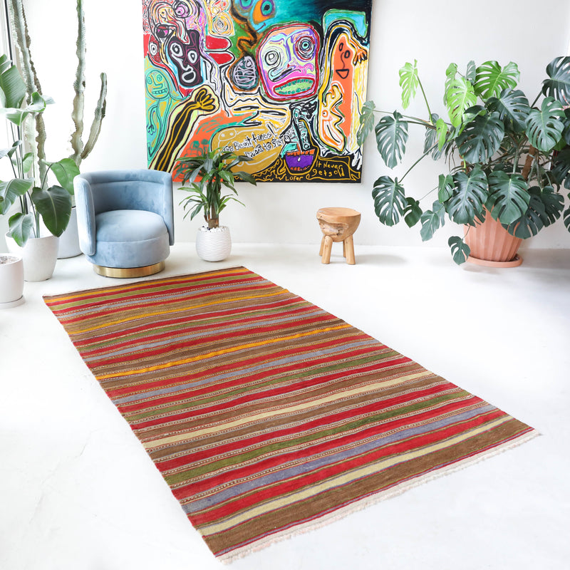 Vintage kilim rug in living room setting, old rug, antique rug, pastel colors, faded colors, Turkish rug, vintage rug, soft rug, Portland, Oregon, rug store, rug shop, local shop, earthy tones, earthy colors, warm colors