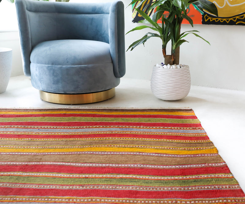 Vintage kilim rug in living room setting, old rug, antique rug, pastel colors, faded colors, Turkish rug, vintage rug, soft rug, Portland, Oregon, rug store, rug shop, local shop, earthy tones, earthy colors, warm colors