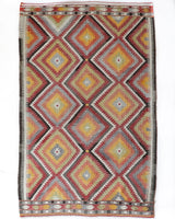 Vintage kilim rug in living room setting, old rug, antique rug, pastel colors, faded colors, Turkish rug, vintage rug, soft rug, Portland, Oregon, rug store, rug shop, local shop, earthy tones, earthy colors, warm colors