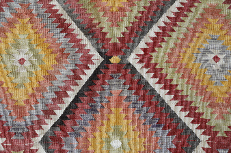 Vintage kilim rug in living room setting, old rug, antique rug, pastel colors, faded colors, Turkish rug, vintage rug, soft rug, Portland, Oregon, rug store, rug shop, local shop, earthy tones, earthy colors, warm colors