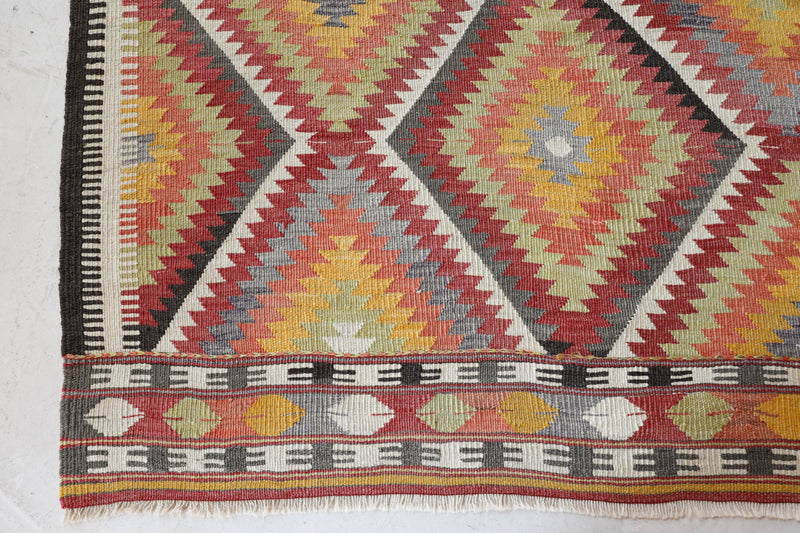 Vintage kilim rug in living room setting, old rug, antique rug, pastel colors, faded colors, Turkish rug, vintage rug, soft rug, Portland, Oregon, rug store, rug shop, local shop, earthy tones, earthy colors, warm colors