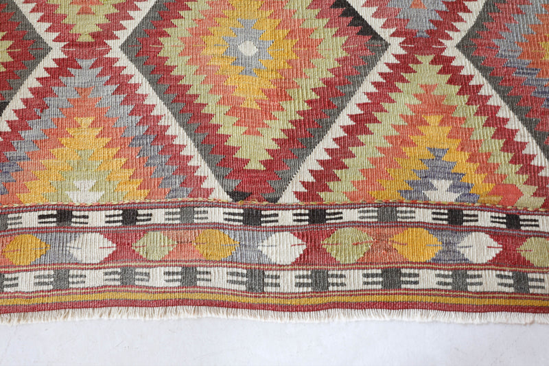 Vintage kilim rug in living room setting, old rug, antique rug, pastel colors, faded colors, Turkish rug, vintage rug, soft rug, Portland, Oregon, rug store, rug shop, local shop, earthy tones, earthy colors, warm colors