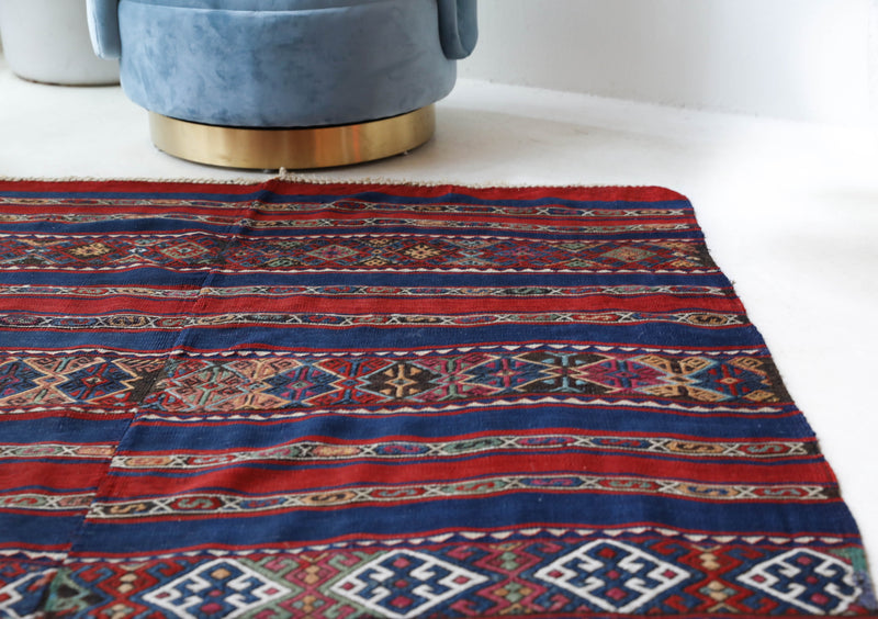 Vintage kilim rug in living room setting, old rug, antique rug, pastel colors, faded colors, Turkish rug, vintage rug, soft rug, Portland, Oregon, rug store, rug shop, local shop, earthy tones, earthy colors, warm colors