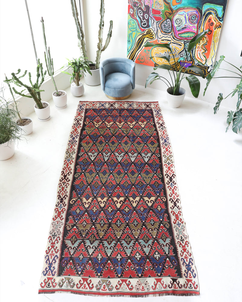 Vintage kilim rug in living room setting, bright colors, wild shaman, soft rug, bold color, Portland, Oregon, rug store, rug shop, local shop, vintage rug, modern kilim, warm colors, antique rug, antique kilim