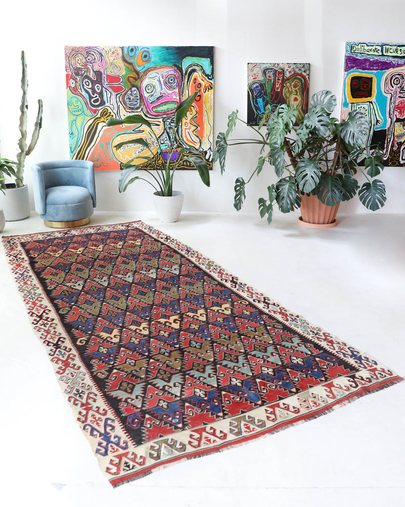 Vintage kilim rug in living room setting, bright colors, wild shaman, soft rug, bold color, Portland, Oregon, rug store, rug shop, local shop, vintage rug, modern kilim, warm colors, antique rug, antique kilim