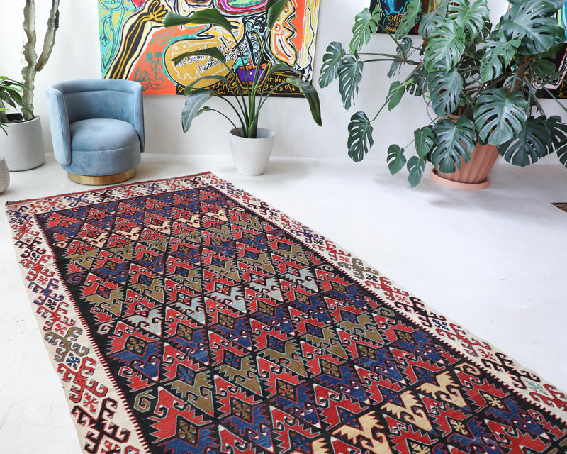 Vintage kilim rug in living room setting, bright colors, wild shaman, soft rug, bold color, Portland, Oregon, rug store, rug shop, local shop, vintage rug, modern kilim, warm colors, antique rug, antique kilim