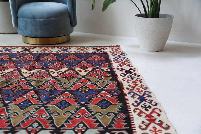 Vintage kilim rug in living room setting, bright colors, wild shaman, soft rug, bold color, Portland, Oregon, rug store, rug shop, local shop, vintage rug, modern kilim, warm colors, antique rug, antique kilim