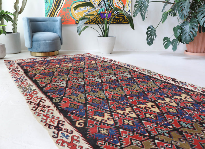 Vintage kilim rug in living room setting, bright colors, wild shaman, soft rug, bold color, Portland, Oregon, rug store, rug shop, local shop, vintage rug, modern kilim, warm colors, antique rug, antique kilim