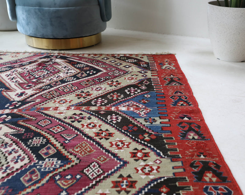  Vintage kilim rug in living room setting, old rug, antique rug, pastel colors, faded colors, Turkish rug, vintage rug, soft rug, Portland, Oregon, rug store, rug shop, local shop, earthy tones, earthy colors, warm colors