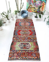 Vintage kilim rug in living room setting, bright colors, wild shaman, soft rug, bold color, Portland, Oregon, rug store, rug shop, local shop, vintage rug, modern kilim, warm colors, antique rug, antique kilim