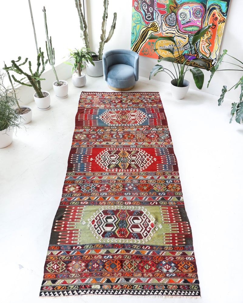 Vintage kilim rug in living room setting, bright colors, wild shaman, soft rug, bold color, Portland, Oregon, rug store, rug shop, local shop, vintage rug, modern kilim, warm colors, antique rug, antique kilim