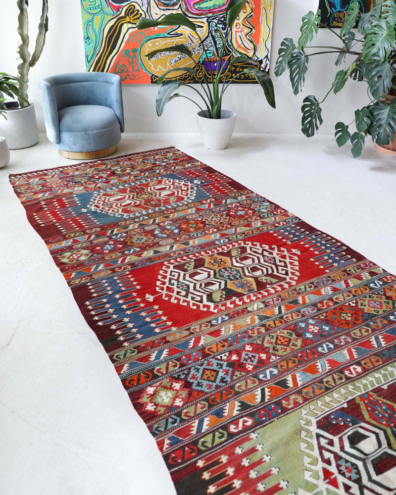 Vintage kilim rug in living room setting, bright colors, wild shaman, soft rug, bold color, Portland, Oregon, rug store, rug shop, local shop, vintage rug, modern kilim, warm colors, antique rug, antique kilim