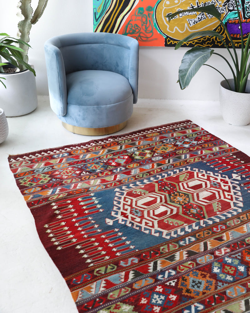 Vintage kilim rug in living room setting, bright colors, wild shaman, soft rug, bold color, Portland, Oregon, rug store, rug shop, local shop, vintage rug, modern kilim, warm colors, antique rug, antique kilim