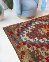 Vintage kilim rug in living room setting, bright colors, wild shaman, soft rug, bold color, Portland, Oregon, rug store, rug shop, local shop, vintage rug, modern kilim, warm colors, antique kilim rug