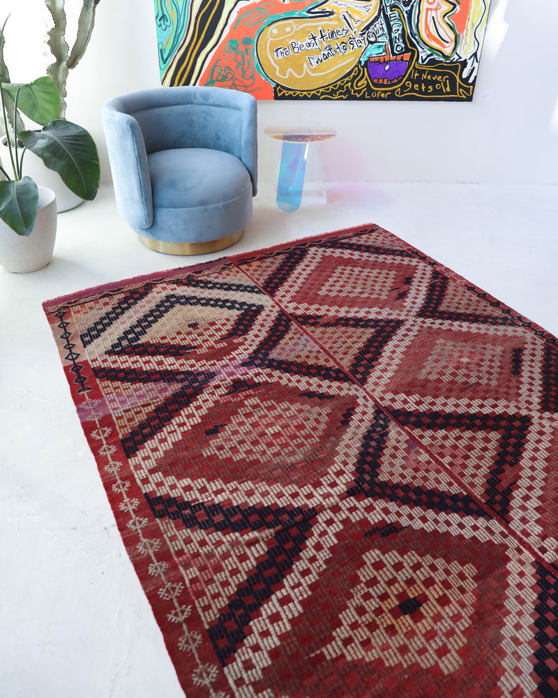 Vintage kilim rug in living room setting, old rug, antique rug, pastel colors, faded colors, Turkish rug, vintage rug, soft rug, Portland, Oregon, rug store, rug shop, local shop, earthy tones, earthy colors, warm colors