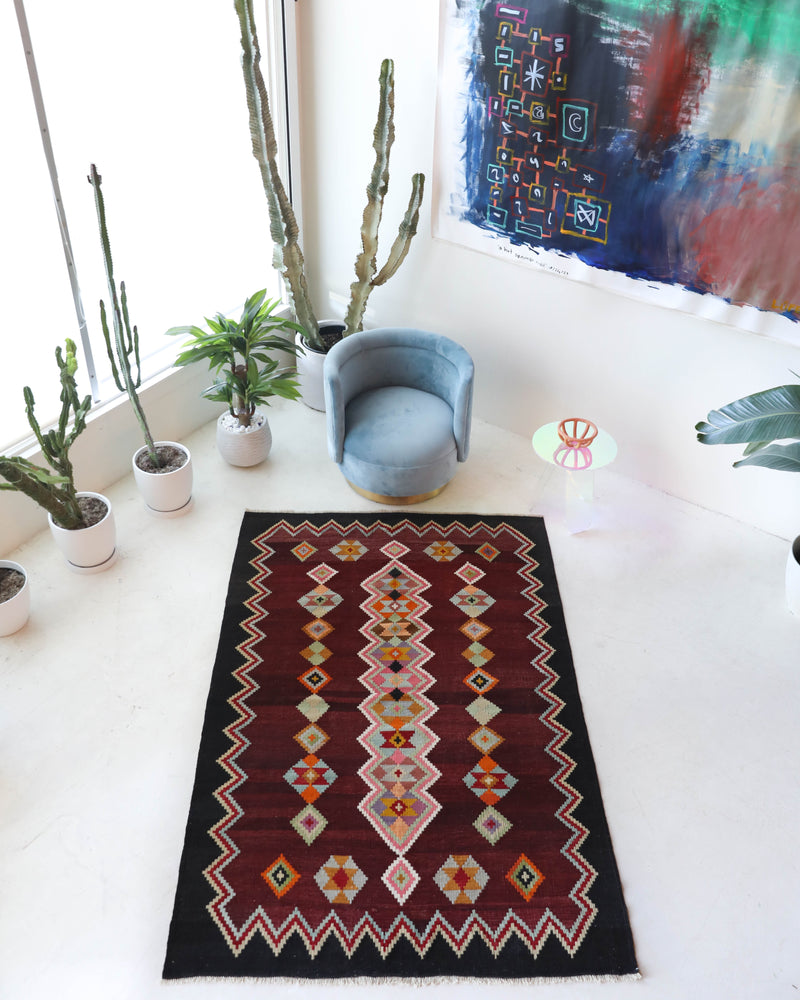 Vintage kilim rug in living room setting, bright colors, wild shaman, soft rug, bold color, Portland, Oregon, rug store, rug shop, local shop, vintage rug, modern kilim, warm colors, antique rug, antique kilim