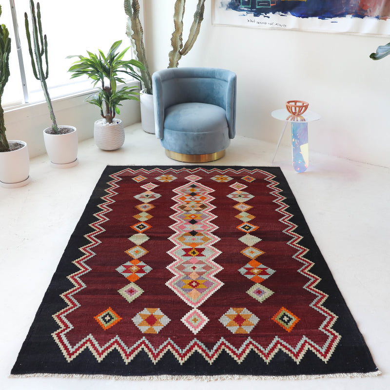 Vintage kilim rug in living room setting, bright colors, wild shaman, soft rug, bold color, Portland, Oregon, rug store, rug shop, local shop, vintage rug, modern kilim, warm colors, antique rug, antique kilim