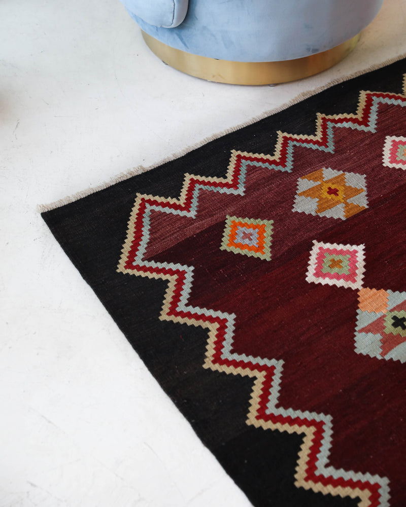 Vintage kilim rug in living room setting, bright colors, wild shaman, soft rug, bold color, Portland, Oregon, rug store, rug shop, local shop, vintage rug, modern kilim, warm colors, antique rug, antique kilim