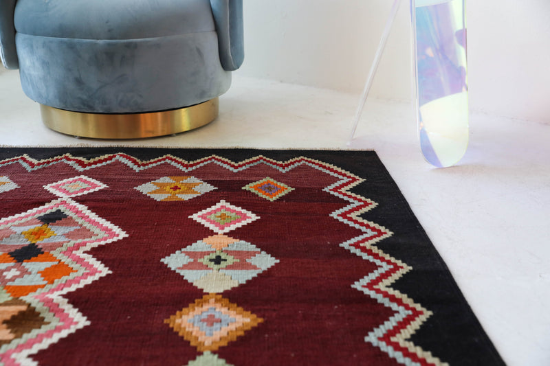 Vintage kilim rug in living room setting, bright colors, wild shaman, soft rug, bold color, Portland, Oregon, rug store, rug shop, local shop, vintage rug, modern kilim, warm colors, antique rug, antique kilim