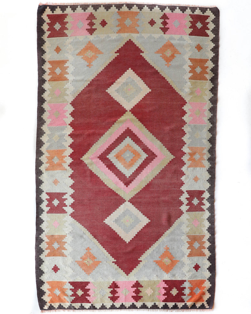 Vintage kilim rug in living room setting, old rug, antique rug, pastel colors, faded colors, Turkish rug, vintage rug, soft rug, Portland, Oregon, rug store, rug shop, local shop, earthy tones, earthy colors, warm colors