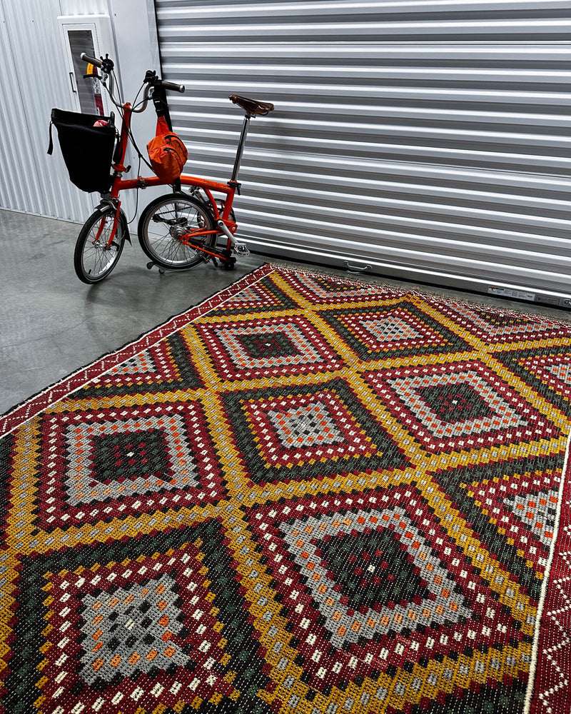 Vintage kilim rug in living room setting, bright colors, wild shaman, soft rug, bold color, Portland, Oregon, rug store, rug shop, local shop, vintage rug, modern kilim, warm colors, antique rug, antique kilim