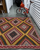 Vintage kilim rug in living room setting, bright colors, wild shaman, soft rug, bold color, Portland, Oregon, rug store, rug shop, local shop, vintage rug, modern kilim, warm colors, antique rug, antique kilim