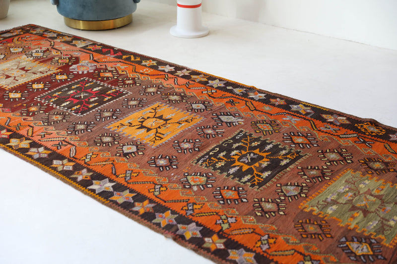 Vintage kilim rug in living room setting, bright colors, wild shaman, soft rug, bold color, Portland, Oregon, rug store, rug shop, local shop, vintage rug, modern kilim, warm colors