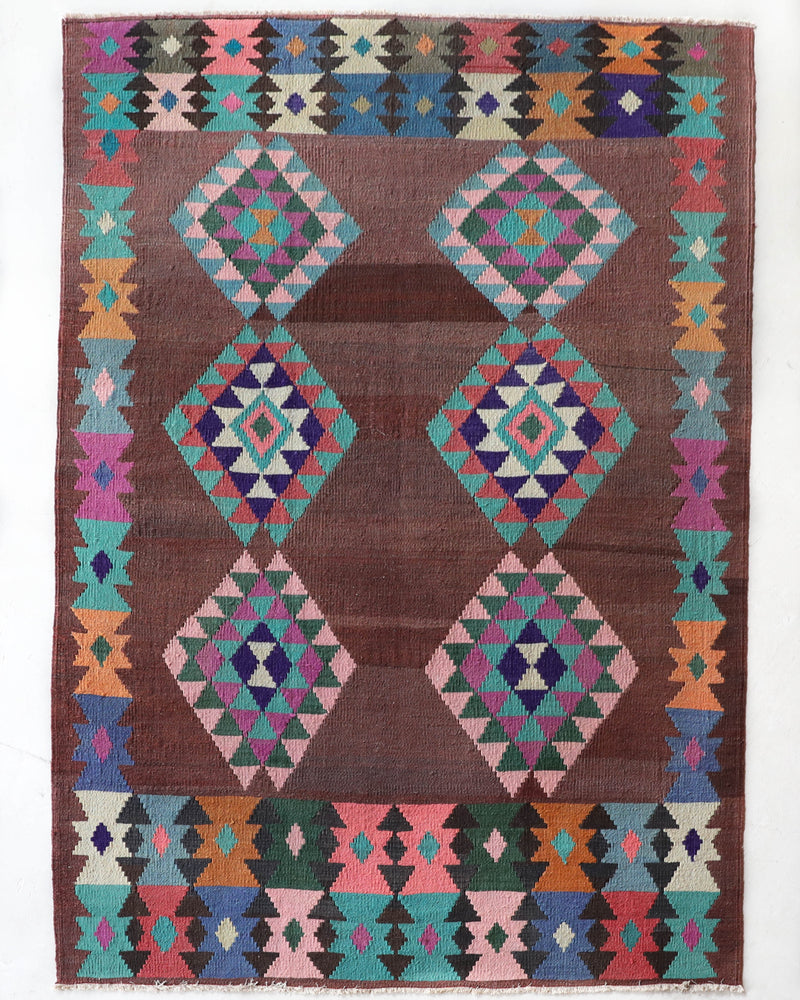 Vintage kilim rug in living room setting, old rug, antique rug, pastel colors, faded colors, Turkish rug, vintage rug, soft rug, Portland, Oregon, rug store, rug shop, local shop, earthy tones, earthy colors, warm colors