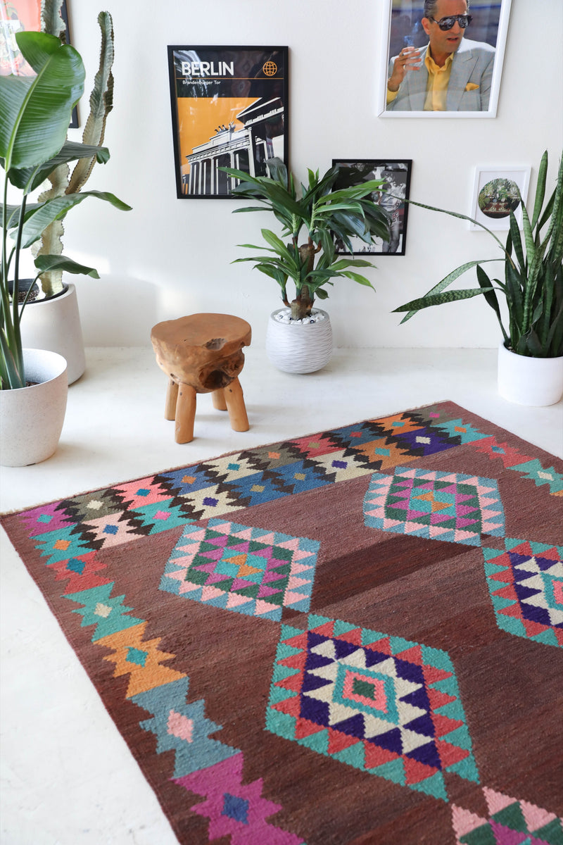 Vintage kilim rug in living room setting, old rug, antique rug, pastel colors, faded colors, Turkish rug, vintage rug, soft rug, Portland, Oregon, rug store, rug shop, local shop, earthy tones, earthy colors, warm colors